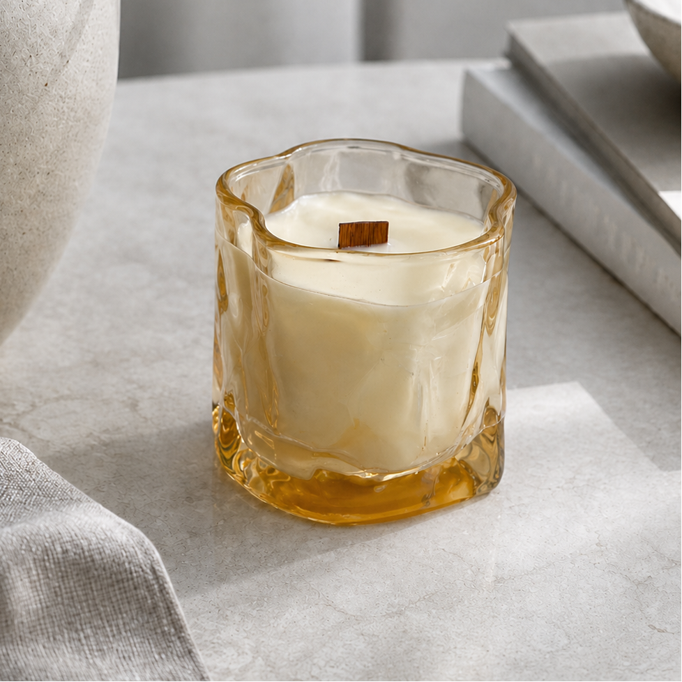 Vela aromática de soja en cristal irregular ámbar en ambiente decorativo