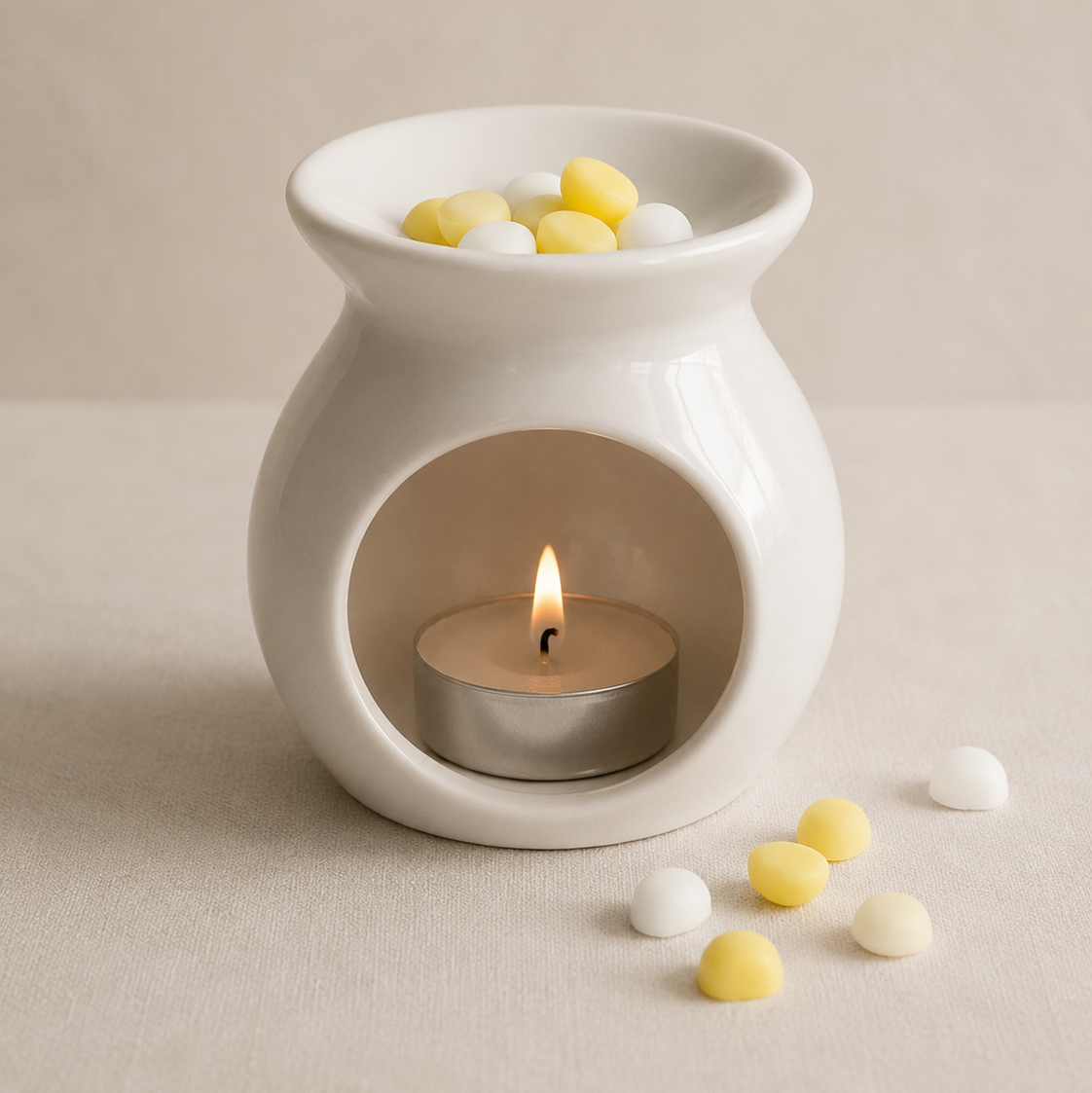 Quemador de wax melts blanco con bolitas aromáticas de coco y cítricos